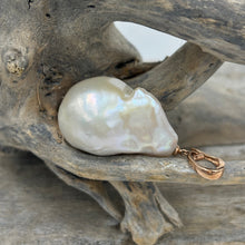 Load image into Gallery viewer, &#39;Kitza&#39; is a stunning large&nbsp; Baroque Freshwater Pearl set in a 9ct Rose Gold enhancer pendant which can be worn on any chain or strand.  This large pearl is 20mm wide and&nbsp; 30mm high with&nbsp; beautiful lustre.  The Pendant is displayed here on a Dark Blue Silk cord, sold separately for $25.
