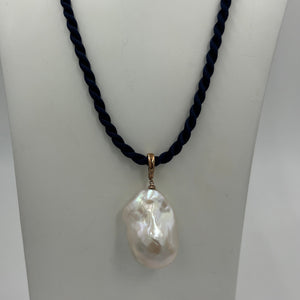 'Kitza' is a stunning large&nbsp; Baroque Freshwater Pearl set in a 9ct Rose Gold enhancer pendant which can be worn on any chain or strand.  This large pearl is 20mm wide and&nbsp; 30mm high with&nbsp; beautiful lustre.  The Pendant is displayed here on a Dark Blue Silk cord, sold separately for $25.