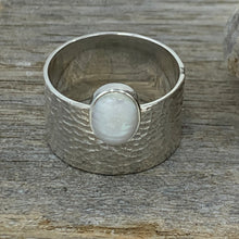 Load image into Gallery viewer, Sterling Silver, textured wide band Ring featuring an offset white mabe/ blister pearl.  The pearl is bezel set and is 8 x 10mm in size  Size 11 only available
