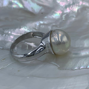 Sterling Silver 'chunky' style ring featuring a beautiful Baroque 13.7mm White Freshwater Pearl held safely inside the large cup.  It is rhodium coated for a non tarnish finish.  One size only 62