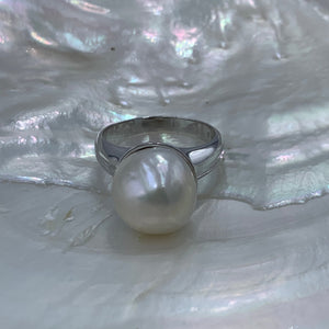 Sterling Silver 'chunky' style ring featuring a beautiful Baroque 13.7mm White Freshwater Pearl held safely inside the large cup.  It is rhodium coated for a non tarnish finish.  One size only 62