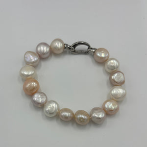 Freshwater pearl bracelet featuring natural pink and white potato shaped pearls, 10 x 13mm in size, with a modern Sterling Silver clasp.  Length including clasp is 20cm