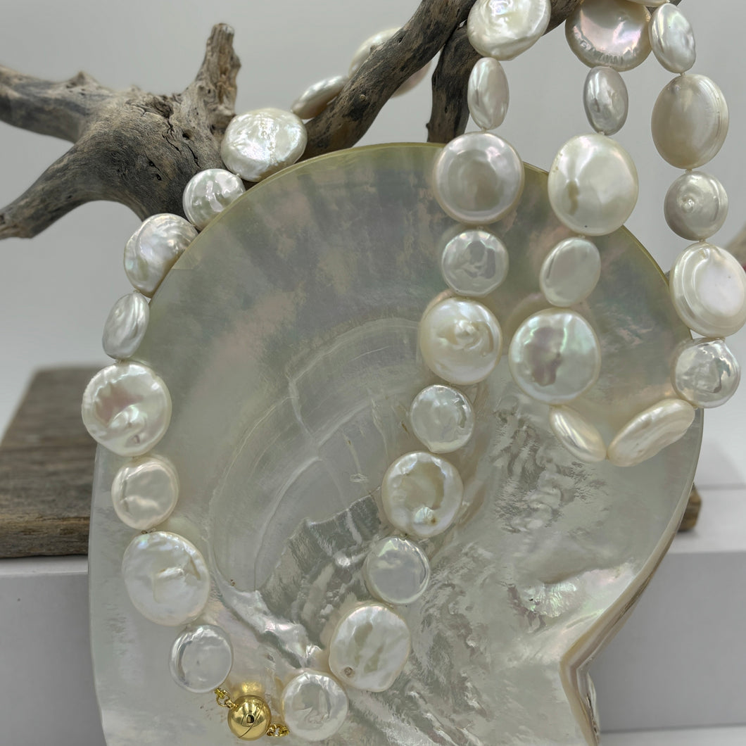 This exceptional quality Long White seedless Coin Freshwater pearl strand features a mix of 15mm and 21mm pearls of high lustre and white with cream hues in color.  It is fully knotted with a strong 10mm magnetic  Gold Plated sterling silver clasp.   The length including clasp is 72cm.  SH469