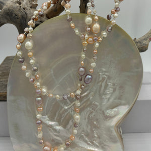 This elegant and versatile necklace is 1.2m long and can be worn in many ways.  It features mixed pearls of natural color and shapes,&nbsp; ranging in size from 3 to 8mm.  The colors range from white, pink and lavender.