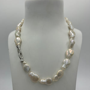 This gorgeous seedless pearl strand looks a little like pear shapes.  It features white with high lustre,&nbsp; 12 x 20mm pearls that have no nuclei so are quite flat in shape. They sit perfectly on any neck.  This strand is fully knotted and features a rhodium coated non tarnish Sterling silver clasp.  The length including clasp is 44cm.