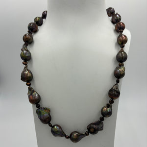 This baroque shape Freshwater Pearl strand/necklace features decadent large 12 x18mm chocolate pearls with rainbow hues,&nbsp; separated with little 3mm 'keshi' pearls.  It is fully knotted and features a 'chanel'' clasp.&nbsp;  The length including clasp is 53cm.