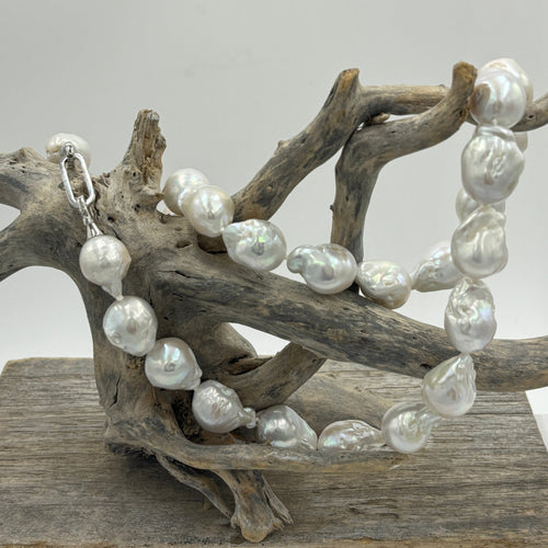 Unique Freshwater pearl strand featuring High lustre 14 x 20mm Baroque pearls, stunning white in colour.  This strand is fully knotted and is 55cm in length, with a sterling silver clasp.