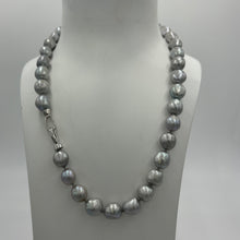 Load image into Gallery viewer, This stunning grey pearl strand is such a versatile color that goes with everything.  It features 11mm semi baroque shaped pearls and a sterling silver clasp.  The length including clasp is 46.5cm
