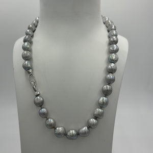 This stunning grey pearl strand is such a versatile color that goes with everything.  It features 11mm semi baroque shaped pearls and a sterling silver clasp.  The length including clasp is 46.5cm