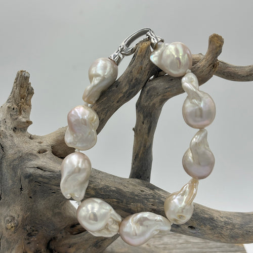 Stunning Freshwater pearl bracelet featuring Nine High lustre Baroque pearls, stunning white in colour and 13-20mm in size.  Fully knotted with a 925 sterling silver clasp.