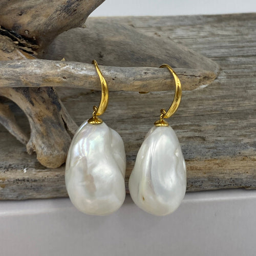 The bold and beautiful earrings are 9ct yellow gold shepherds hook style Earrings featuring 19 x 25mm high lustre Baroque shape Freshwater Pearls, White with rainbow hues.

These are 40mm from top to bottom
