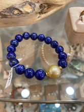 Load image into Gallery viewer, Australian South Sea Pearl Bracelet featuring 10mm natural Blue Lapis beads and with a Golden South Sea Pearl, Oval in shape, 12.6 x 13mm in size with high lustre  This bracelet is on strong 1mm elastic from US  J3312
