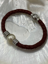 Load image into Gallery viewer, &#39;Pam&#39; is a braided leather bracelet featuring a white Circle Button 12.1mm South Sea Broome pearl

This bracelet is made out of braided dark brown leather and a stainless steel magnetic clasp
