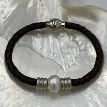 Load image into Gallery viewer, &#39;Pam&#39; is a braided leather bracelet featuring a white Circle Button 12.1mm South Sea Broome pearl

This bracelet is made out of braided dark brown leather and a stainless steel magnetic clasp
