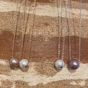 This Slider necklace features a single 10-11mm Round freshwater pearl   Choose a Pink, White or Grey pearl  Then choose if you want a rose gold or silver chain  The chain is Sterling Silver Trace Chain with a protective cheneer tube through the pearl for protection and easy sliding  The chains are adjustable in length from 40cm or 45cm