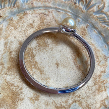 Load image into Gallery viewer, Sterling Silver solid bangle featuring an Indonesian South Sea Pearl  This stunning  pearl  is an Australian South Sea pearl,  Button in shape and 12.7mm in size. It is Deep Gold in color with High lustre and is featured on this rhodiun coated non tarnish bangle   J3294
