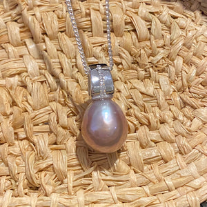 Sterling silver and rhodium coated  pendant featuring Baroque Drop shaped natural lavender color freshwater pearl, Lavender with pink hues, 11.5 x 14.5mm in size, nice lustre  This pendant features a row of Cubic Zirconia 