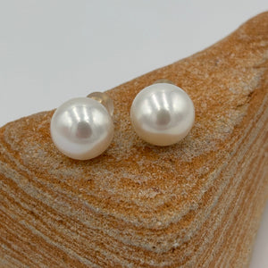 These large white Freshwater pearl studs are 12.3 mm in size, Button in shape and have lovely pink hue to the white colour and high lustrre.'

They are set on 9ct yellow gold settings.