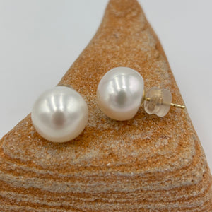 These large white Freshwater pearl studs are 12.3 mm in size, Button in shape and have lovely pink hue to the white colour and high lustrre.'

They are set on 9ct yellow gold settings.