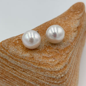 These large white Freshwater pearl studs are 11.5mm in size, Button in shape and are&nbsp; white colour and high lustrre.'

They are set on 925 Sterling silver&nbsp; settings.