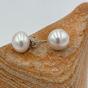 These large white Freshwater pearl studs are 11.5mm in size, Button in shape and are&nbsp; white colour and high lustrre.'

They are set on 925 Sterling silver&nbsp; settings.