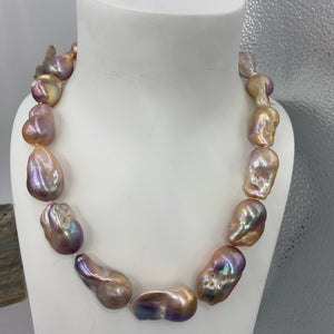 Unique Freshwater pearl strand featuring High lustre 18 x 30mm Baroque pearls, stunning shades of Lavender and pinks in colour.

This strand is fully knotted and is 43cm in length, with a gold plated sterling silver clasp.