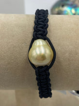Load image into Gallery viewer, Thick Black Macrame bracelet featuring an Indonesian South Sea Pearl, Circle Drop in shape, 13.2 x 14.8mm in size, Gold in colour, high lustre and clean skin.  (J3317)  This bracelet is made from water and colorfast nylon material for heavy duty wear and tear, features no glue and no metal parts
