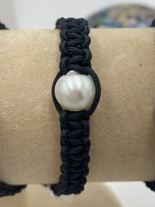 Macrame bracelet (thick thread black) featuring an Australian South Sea Pearl, Button in shape, 10.5mm in size, white in colour.  (J3321)  This bracelet is made from water and colorfast nylon material for heavy duty wear and tear, features no glue and no metal parts   Pictured 2nd from left in group photo