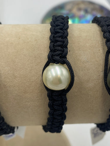 Macrame bracelet (thick thread black) featuring an Australian South Sea Pearl, Button in shape, 11.3mm in size, Champagne in colour.  (J3320)  This bracelet is made from water and colorfast nylon material for heavy duty wear and tear, features no glue and no metal parts   Pictured second from right in group photo
