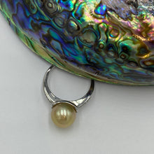 Load image into Gallery viewer, This adorable Golden Indonesian South Sea pearl ring is set in 925 sterling silver with cubic zirconia along the band and its rhodium coated for a white gold look and anti tarnish  It features a natural gold pearl, Button shape and 10.1mm in size  It has good lustre and very light &#39;birthmarks&#39;  J3207   Size Q (58) or 8.5
