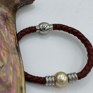 <p>'Lydia' is a braided leather bracelet featuring a Golden South Sea Pearl</p> <p>Pearl is a near round in shape, 12.4mm in size and is golden in colour</p> <p>This bracelet is made out of braided brown leather and stainless steel with a magnetic clasp</p> <p>J3349</p>