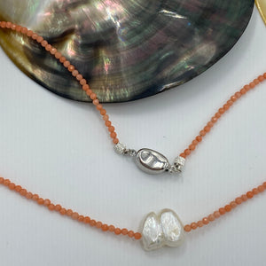 <p><span>This necklace features a white Freshwater Keshi or seedless Pearl&nbsp; on a necklace of 2.5mm facetted Orange Bamboo Coral gemstones with a sterling silver peanut clasp</span></p> <p><span>The pearl is 12.5 x 15mm in size</span></p> <p>The overall length is 46cm</p> <p>Other gemstone necklaces can be made to order</p>