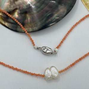 <p><span>This necklace features a white Freshwater Keshi or seedless Pearl&nbsp; on a necklace of 2.5mm facetted Orange Bamboo Coral gemstones with a sterling silver peanut clasp</span></p> <p><span>The pearl is 12.5 x 15mm in size</span></p> <p>The overall length is 46cm</p> <p>Other gemstone necklaces can be made to order</p>