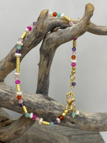 This bright and colorful gemstone and pearl necklace adds sunshine to any outfit.

Made from 18k yellow gold plated sterling silver and featuring various gemstones with a length of 38cm and  extension chain of 5cm.

The pearls are 3.5mm and the gemstones are Carnelian, Amethyst, Amazonite, and Rose lisa.

It comes in Pink or Blue and has a matching bracelet that can be ordered separately