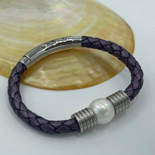 Load image into Gallery viewer, &lt;p&gt;&#39;Pam P&#39; is a braided leather bracelet featuring a white Freshwater Pearl&lt;/p&gt; &lt;p&gt;The pearl is round in shape, 12.8mm in size and is white in colour&lt;/p&gt; &lt;p&gt;This bracelet is made out of braided purple leather and stainless steel with an adjustable metal clasp&lt;/p&gt;

