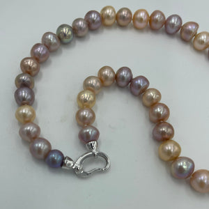 <p>Freshwater Edison pearl strand featuring natural multicolour pearls, natural shades of Pink through to Lavender round shaped pearls, 10 - 11mm in size, with a Sterling Silver clasp.</p> <p>45cm in length</p> <p>Matching bracelet available featuring an identical clasp - these can be joined together to make a 65cm strand</p> <p>INS</p>