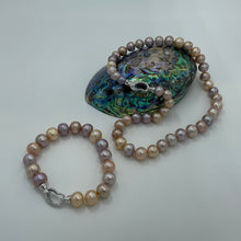 Load image into Gallery viewer, &lt;p&gt;Freshwater Edison pearl strand featuring natural multicolour pearls, natural shades of Pink through to Lavender round shaped pearls, 10 - 11mm in size, with a Sterling Silver clasp.&lt;/p&gt; &lt;p&gt;45cm in length&lt;/p&gt; &lt;p&gt;Matching bracelet available featuring an identical clasp - these can be joined together to make a 65cm strand&lt;/p&gt; &lt;p&gt;INS&lt;/p&gt;
