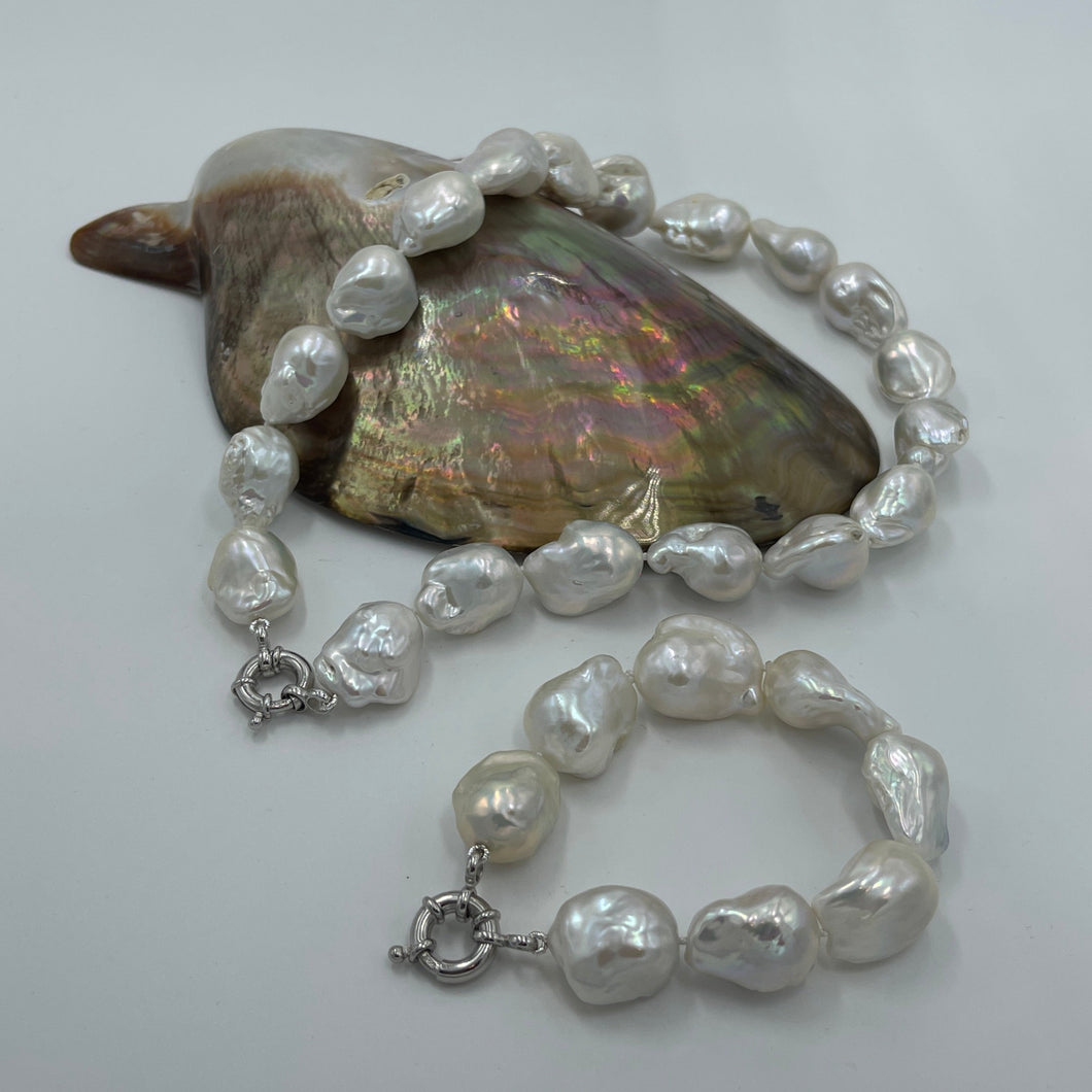 Stunning Freshwater pearl strand featuring High lustre Baroque pearls, stunning white in colour and 15-30mm in size.  Fully knotted with a 925 sterling silver bolt ring clasp.  Length including clasp is  45cm.  Matching bracelet  available (see photos) and these can be joined together to make a 66.5cm strand  INS