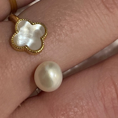This stunning ring is adjustable in size and features white Mother of Pearls shell in the shape of a four leaf clover   It is 14k gold plated over 925 Sterling silver ring  AK