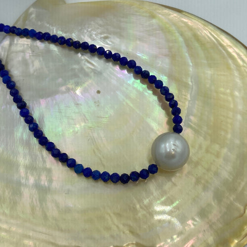 Australian South Sea pearl necklace with faceted Lapis gemstones and a sterling silver peanut clasp.  This beautiful necklace features an Australian South Sea pearl , round in shape, and 11.3mm in size. It is white with silver hues in colour.  Vibrant 3mm Lapis and the overall length including clasp is 45cm.  Good lustre and light natural 'birthmarks'.