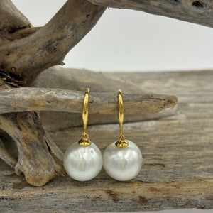 Australian South sea pearl earrings on 9ct Yellow gold shepherd hooks.&nbsp;  They feature Baroque Drop shaped pearls,&nbsp; 12mm x 13mm in size and White with Silver hues in color.    J3476