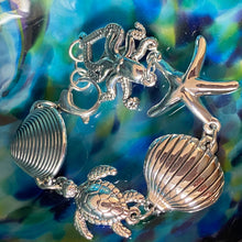 Load image into Gallery viewer, This statement bracelet is every mermaids dream piece of jewellery

It is crafted in 925 Sterling silver and features an Octopus, Turtle, Starfish and two different shells. The octopus is 30mm wide and the Turtle is 25mm

Large lobster clasp&nbsp;

Length 19cm and can be shortened by a link
