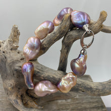 Load image into Gallery viewer, Stunning Freshwater pearl bracelet featuring Eight High lustre natural color Baroque pearls, stunning natural lavender, pink, apricot and Gold tones in colour and 14-25mm in size.

Fully knotted with a 925 sterling silver clasp (non tarnish finish).

Length overall is 21cm
