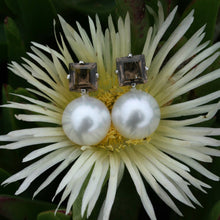 Load image into Gallery viewer, The large Australian South sea pearl earrings have been handcrafted in  925 sterling silver with large Claw set square Smoky Quartz stud fittings   They feature Button shape , 12.1mm Australian pearls that are White with Pink hues.  They are AAA grade with high lustre and clean skin  J3309
