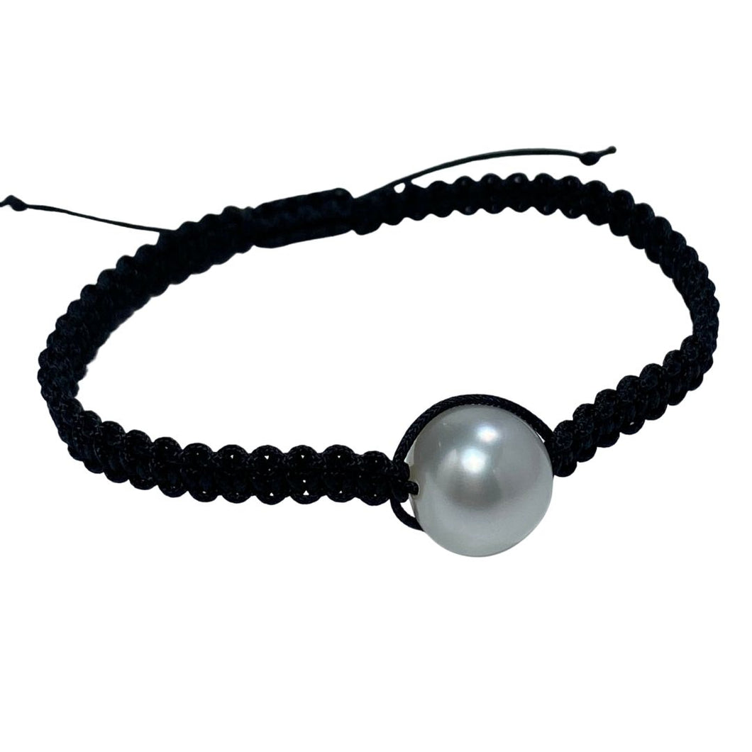 Thin Black Macrame bracelet featuring an Australian South Sea Pearl, Button shape, 11.3mm in size, White with Pink hues.  (J2876)  This bracelet is made from water and colorfast nylon material for heavy duty wear and tear, features no glue and no metal parts