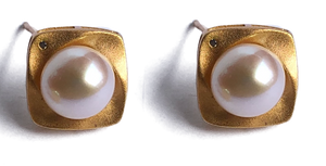 18K gold plated over 925 sterling silver stud style earrings  Satin finish studs with a cubic zirconia and Button shaped Freshwater pearls 7.5-8mm  Overall earring length of 15mm.  Matching pendant available named 'Swirl' pendant 
