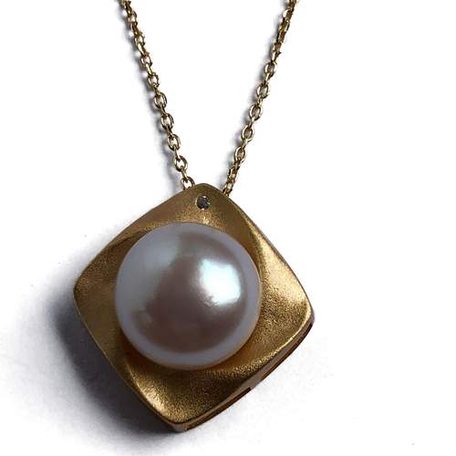 18K gold plated over 925 sterling silver pendant and chain  Satin finish Swirl pendant 20mm from top to bottom, holding a Button shape White Freshwater pearl 11.5-12mm and featuring a small cubic zirconia  Chain is adjustable from 40 to 46cm in length  Matching earrings available named 'Swirl' earrings
