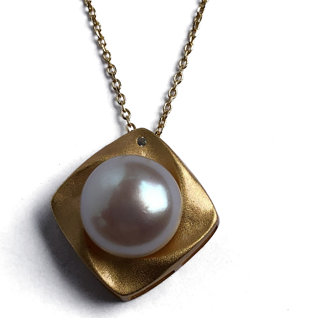 18K gold plated over 925 sterling silver pendant and chain  Satin finish Swirl pendant 20mm from top to bottom, holding a Button shape White Freshwater pearl 11.5-12mm and featuring a small cubic zirconia  Chain is adjustable from 40 to 46cm in length  Matching earrings available named 'Swirl' earrings