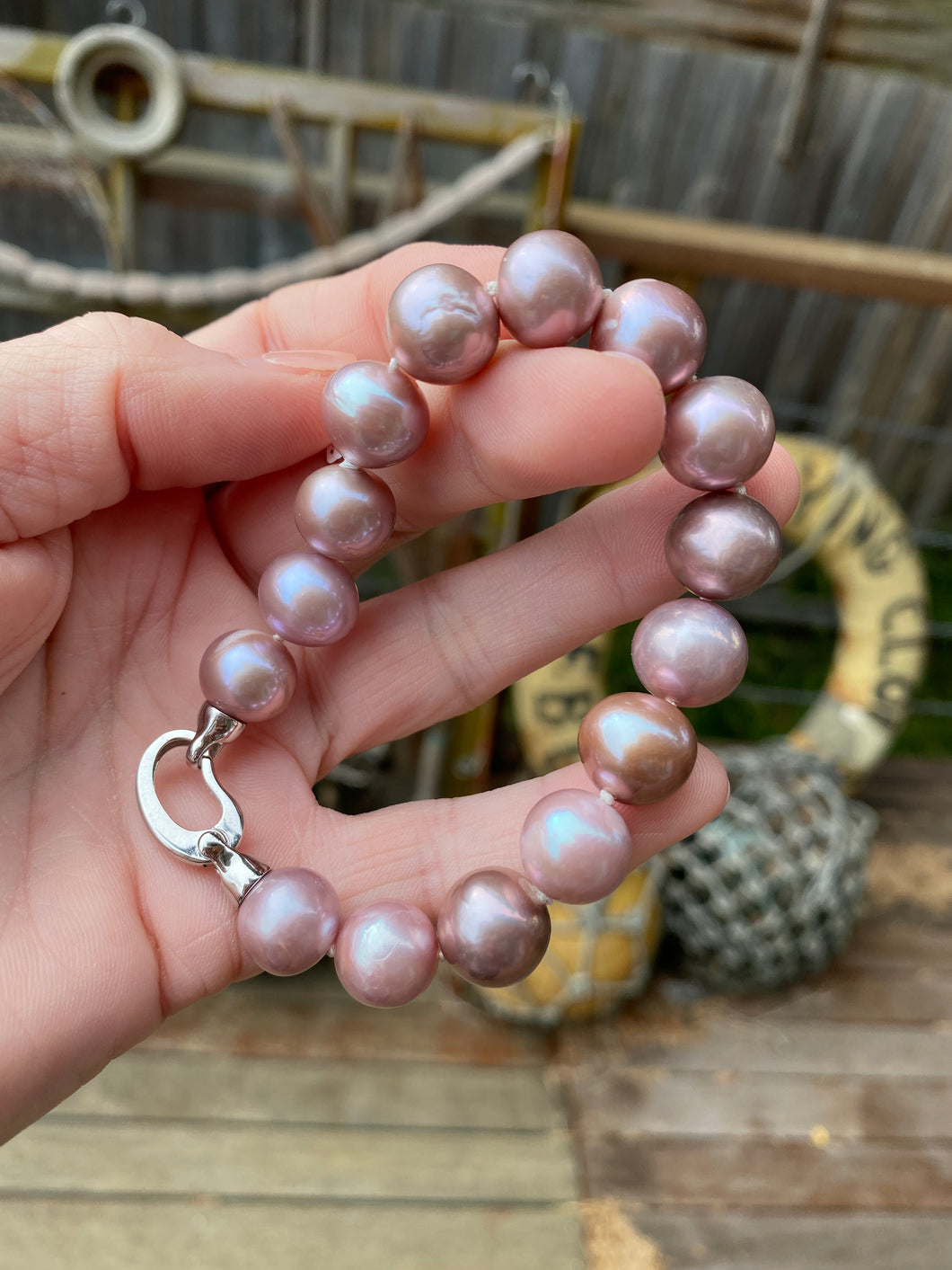 Kasumi Japanese Freshwater pearl bracelet featuring natural lavender color Round shape pearls 11 - 13mm in size  There are 15 pearls and it features  a modern 925 Sterling Silver clasp  Length 20cm