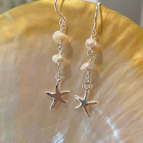 Sterling Silver Shepherds Hook earrings featuring white 6mm seedless keshi pearls  and silver starfish  Total length of earring is 40mm  Available in silver or gold - please select 
